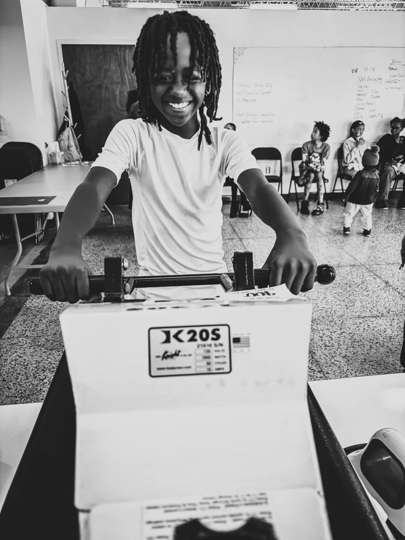 A young printer pulls the heat press handle.