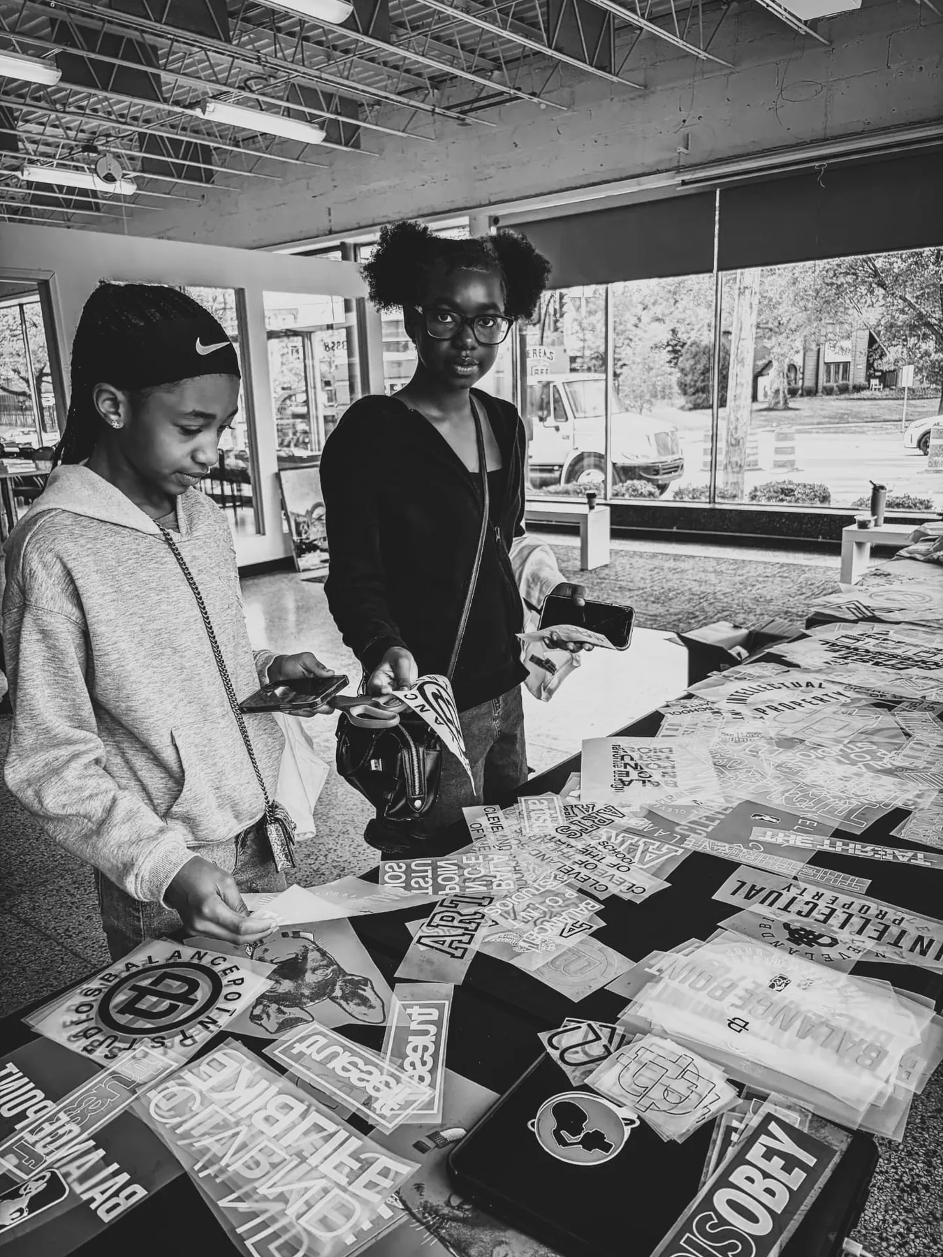 Two young printers pick transfers at the table.